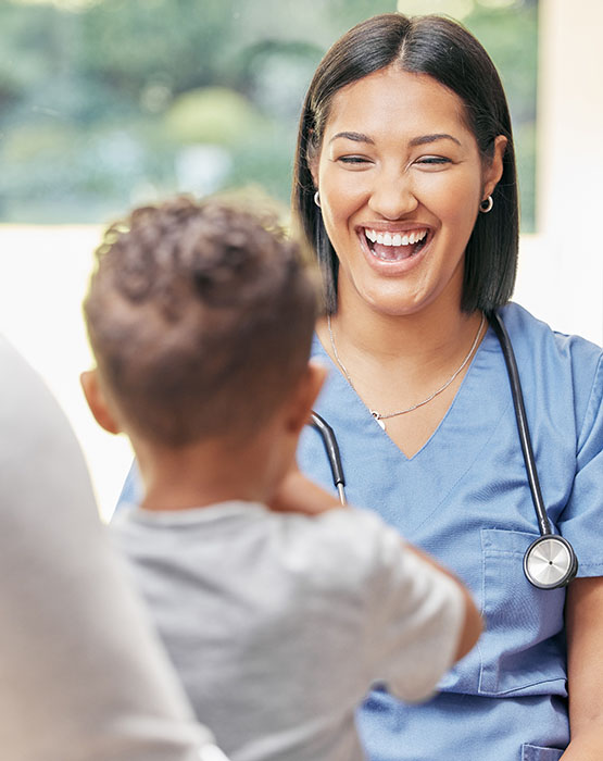 Female doctor smiling at boy