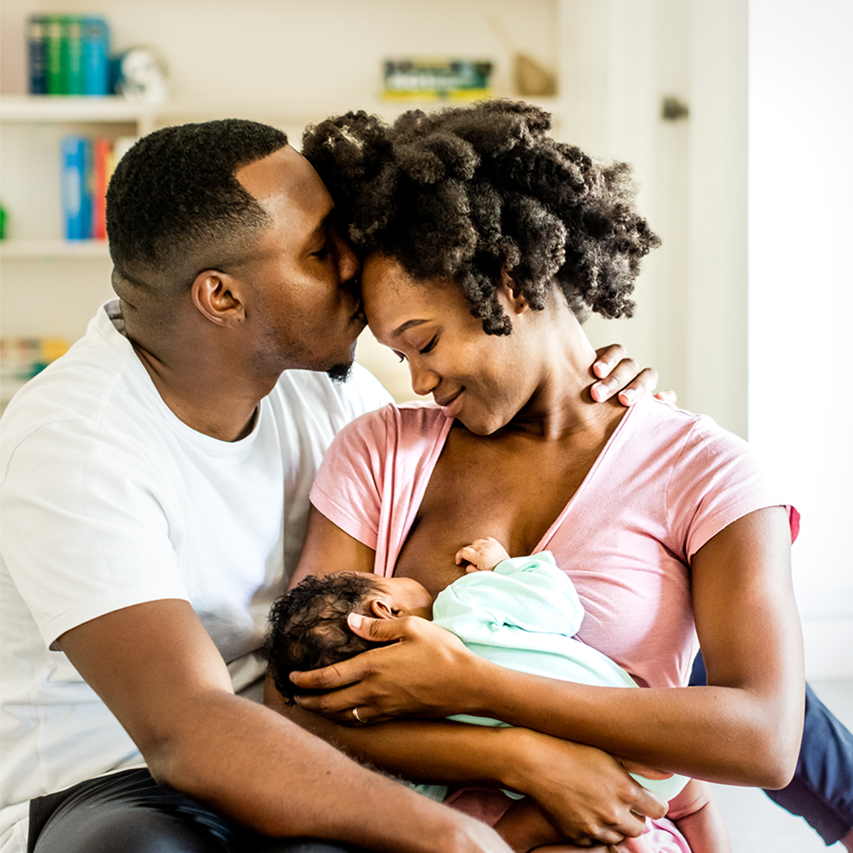 Father and Mother with infant breastfeeding.