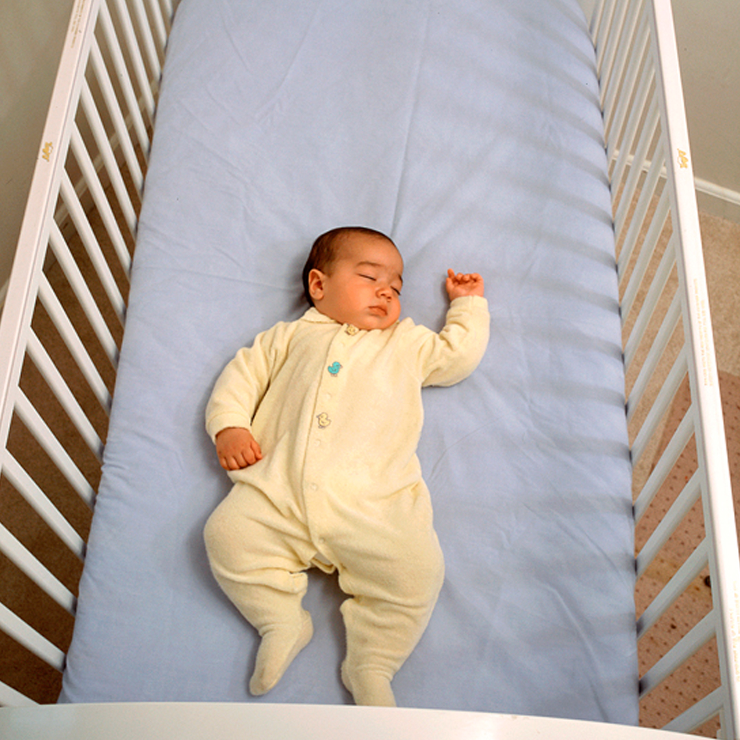 Infant sleeping in crib