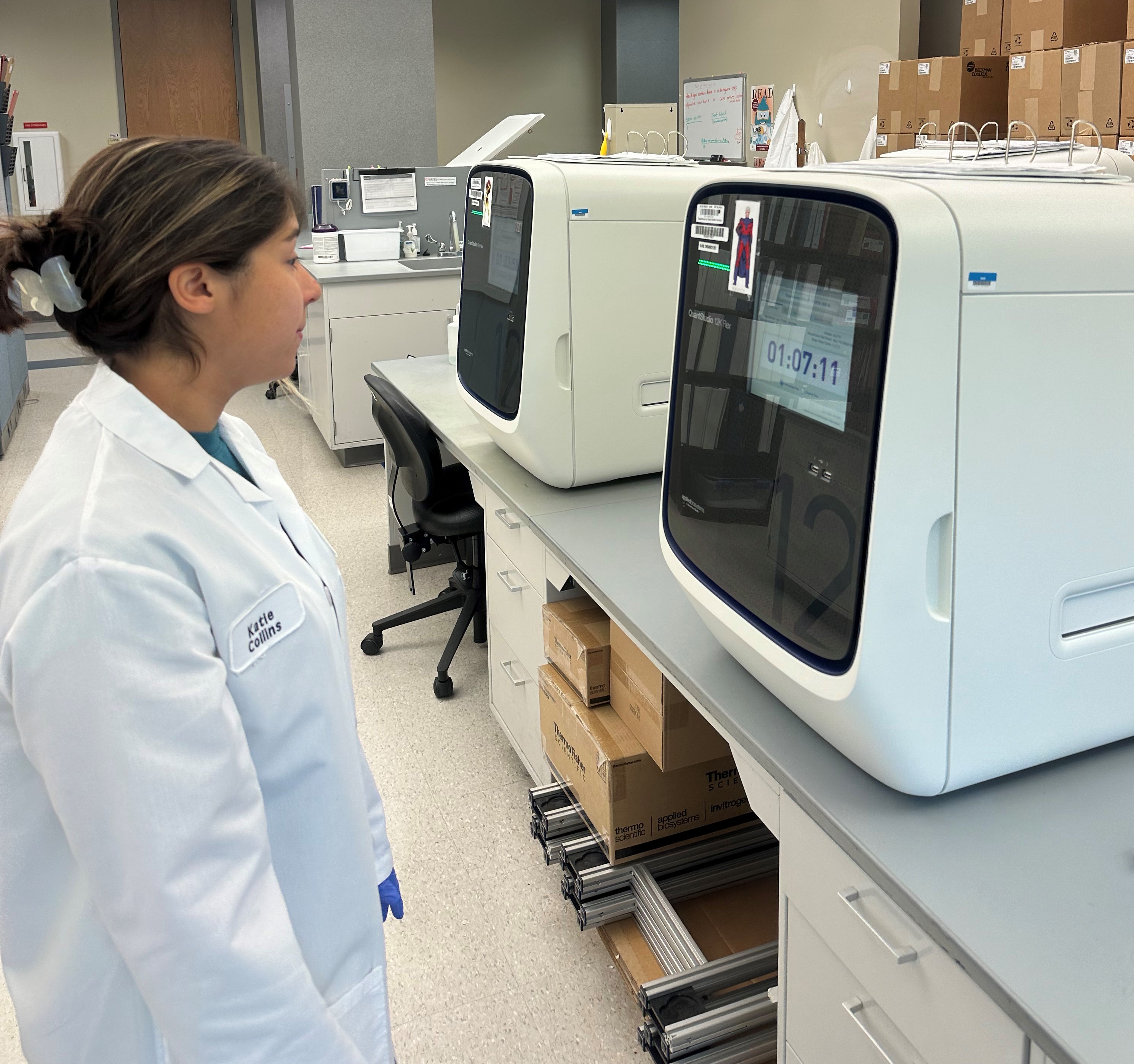 Laboratory Technician on SKID SMA Team running an instrument. 