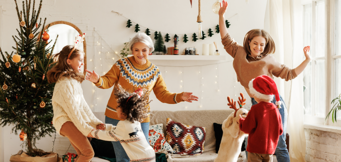 A family dancing in the living room during Christmas.